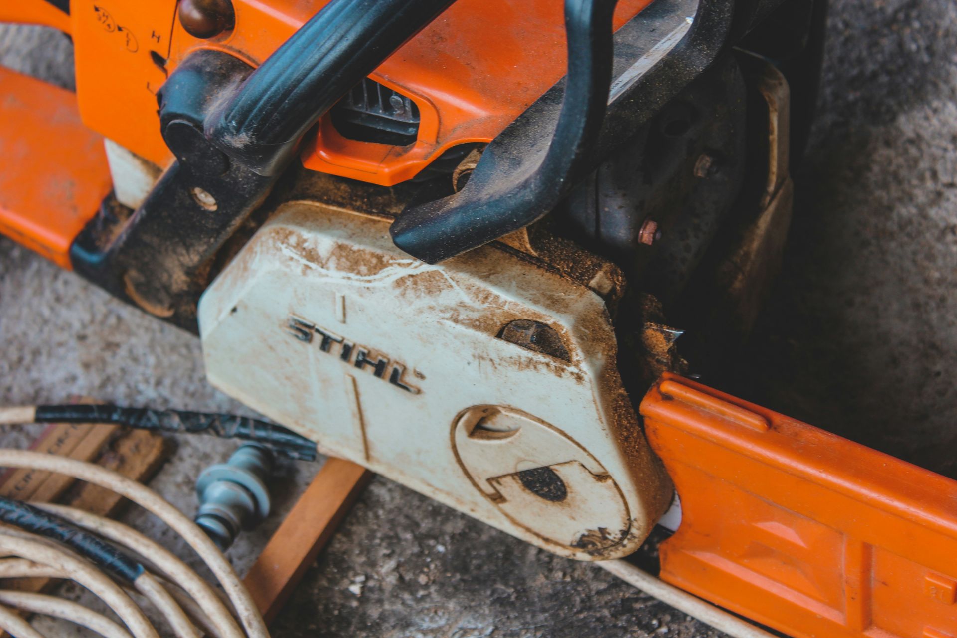 a close up of a chainsaw on the ground